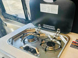 Prepare meals in your rv rental with this efficient two-burner stove. Stainless steel, control knobs, and a protective lid.