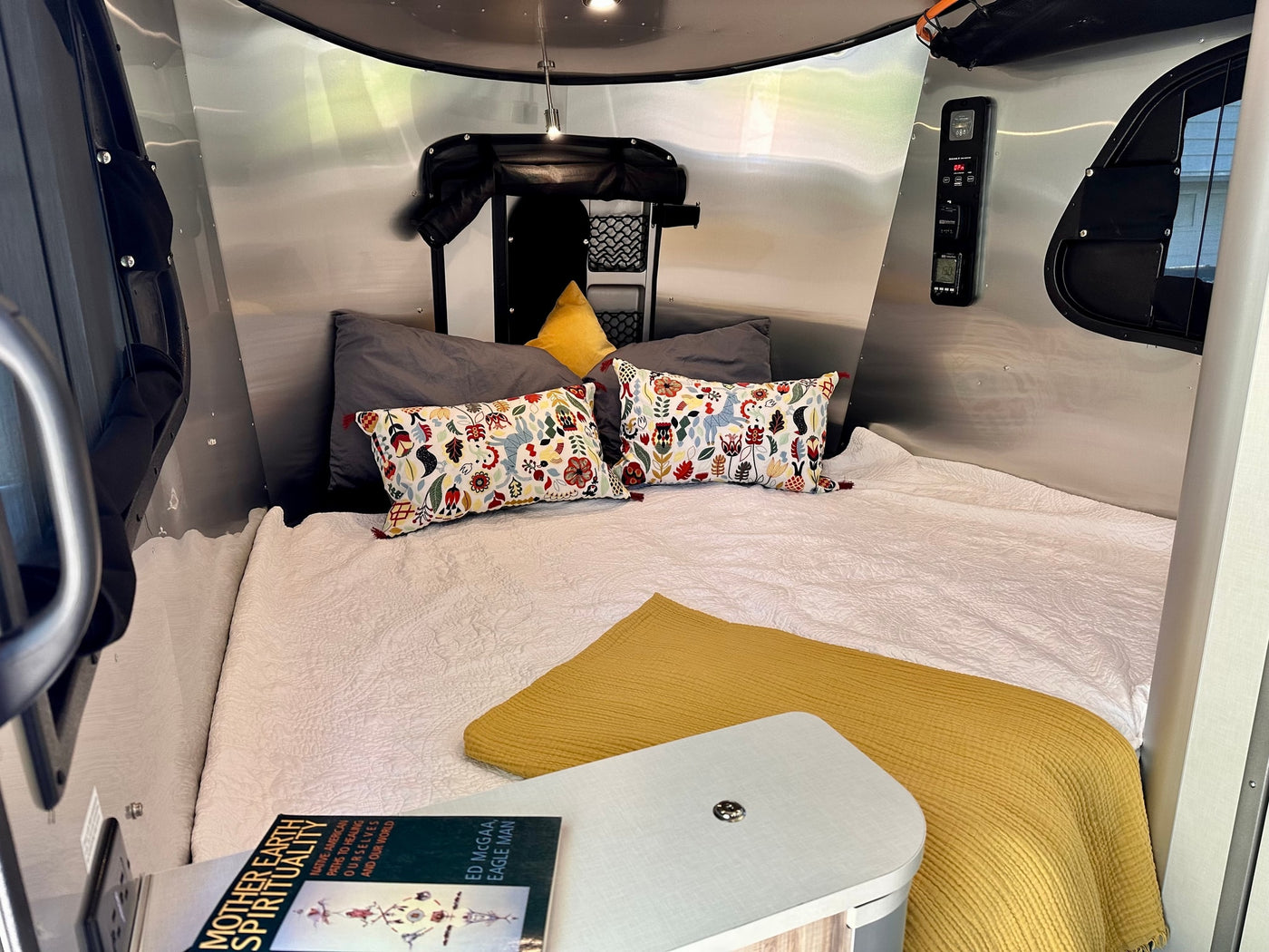  offering scenic outdoor views.|Open back door reveals modern rv rental interior with dining table — photo 12