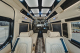 Premium RV rental interior featuring cream quilted leather seats, wood-grain floors, and modern lighting for ultimate comfort.