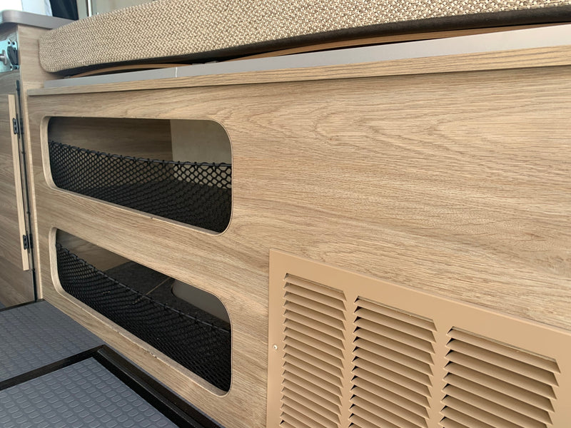  revealing a cozy interior with bed & utility panel. Ideal for an RV rental adventure.|Inside an RV rental: rear view of the living area with light wood cabinetry — photo 8