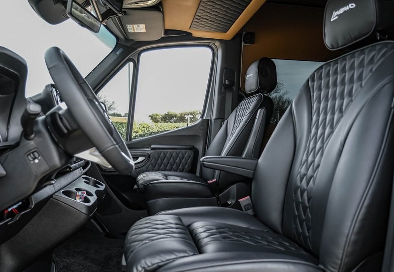 Luxurious black leather, diamond-stitched seats, steering wheel, and dashboard inside this premium RV rental. — photo 8