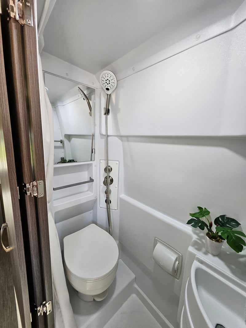  and bright windows for your next adventure.|This RV rental features a compact — photo 8