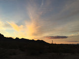 Stunning desert sunset over silhouetted mountains & cacti. Ideal scenic backdrop for your next RV rental adventure.
