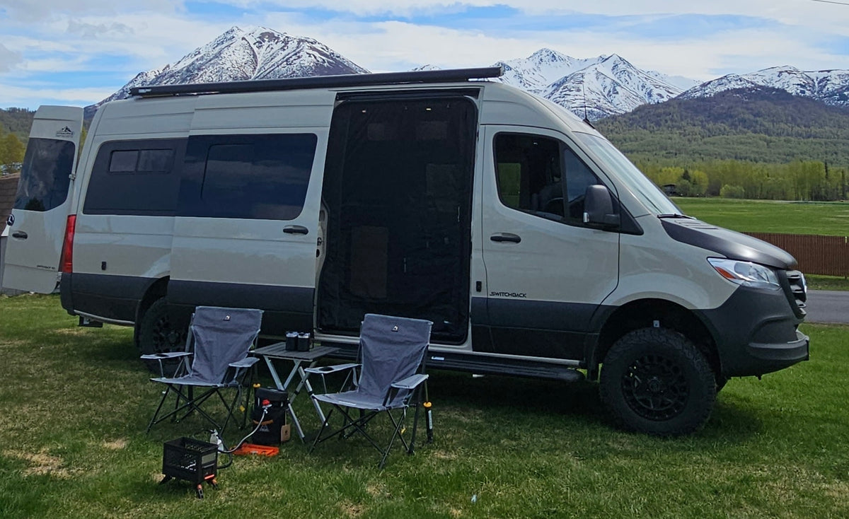  and other RVs in the background.|An RV rental camper van with open doors — photo 5