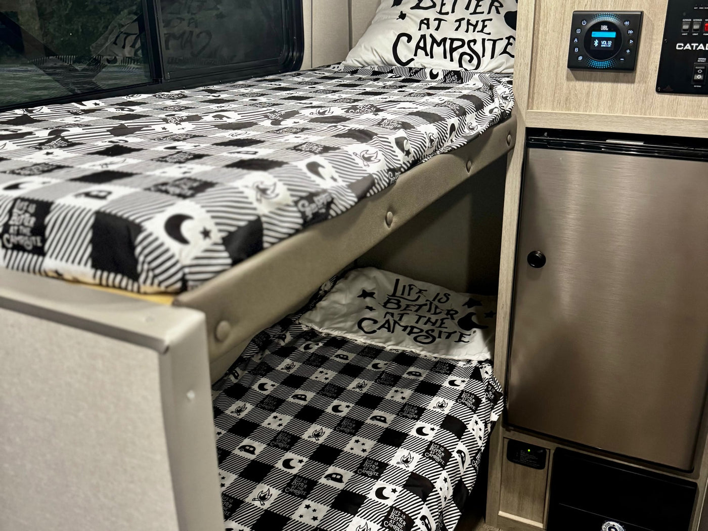  and power cord with surge protector on green grass.|An RV rental with its awning and blue LED lights extended — photo 7