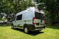 Explore the open road in this silver camper van, perfect for your RV rental adventure. Parked on a sunny green lawn. — photo 5