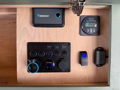 RV rental control panel: displays for Renogy charge controller & Victron battery, switches for pump/lights, USB/12V power.