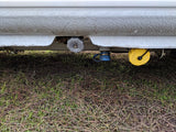 Inspecting rv rental utility points: gas, water, and drain connections clearly visible below.