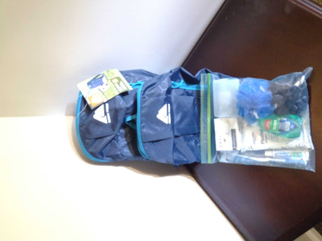 RV rental ready: Blue Ozark Trail bag and clear bag of toiletries including mouthwash, wipes, and bath pouf.