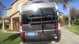 Rear view of a gray Ram ProMaster RV with a Thule bike rack, perfect for your next rv rental adventure.