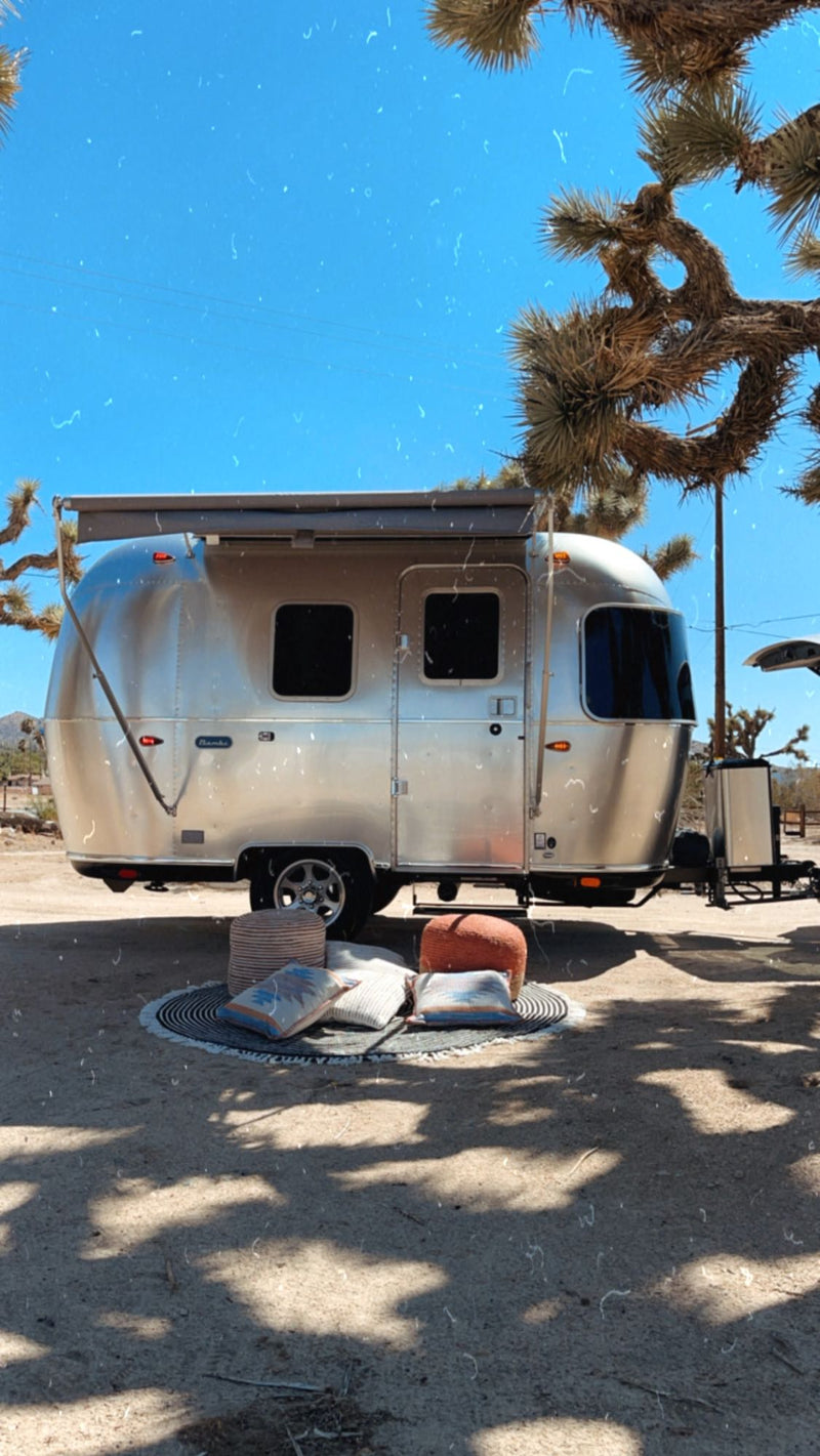  ideal for an RV rental adventure in Joshua Tree.|Cozy rv rental interior with sun-patterned bedding — photo 3