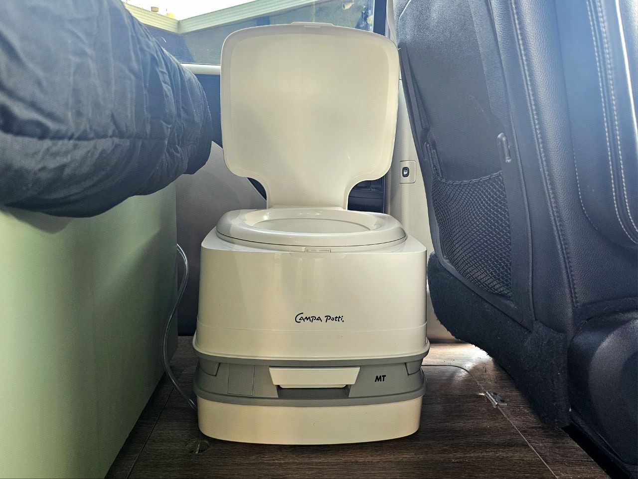 A portable Campa Potti inside an rv rental camper van, providing on-the-go bathroom convenience for travel. — photo 13