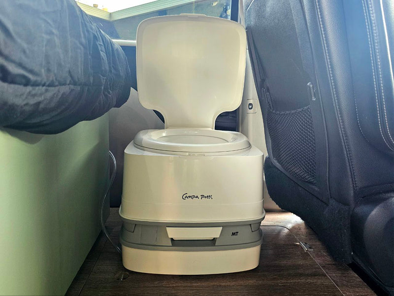A portable Campa Potti inside an rv rental camper van, providing on-the-go bathroom convenience for travel. — photo 13