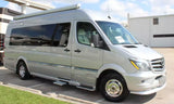 Silver Mercedes-Benz Sprinter RV rental van, ideal for travel. Parked outside on a sunny day.