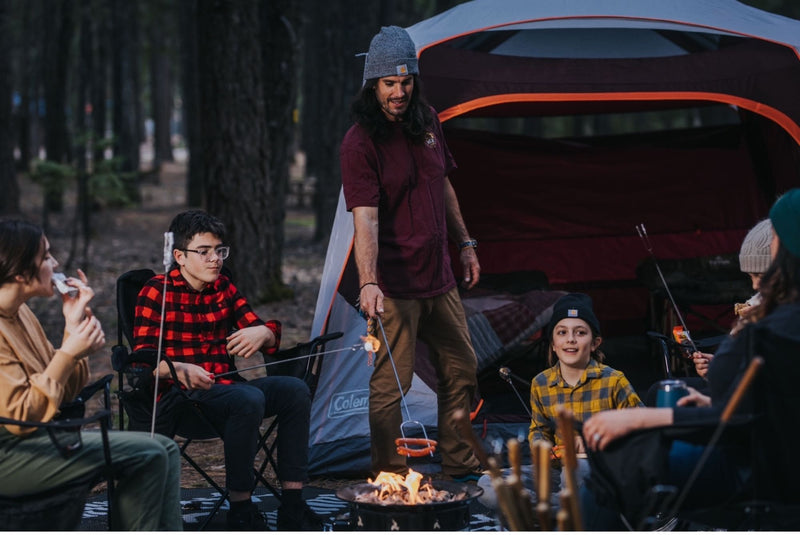 great for an RV rental trip.|Friends gather around a campfire in a lush forest campsite. Ideal outdoor fun after an RV rental journey.|Forest RV rental retreat: Canopy-covered picnic — photo 18