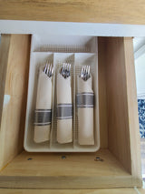 RV rental: Efficiently organized forks in a white tray inside a compact drawer, ready for your adventures.