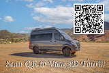 Gray adventure RV rental parked in a mountainous outdoor setting. Scan the QR code to take a 3D tour of this camper van.
