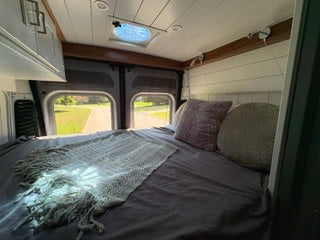  and a cozy bed in this van conversion.|RV rental: Cozy campervan interior — photo 4