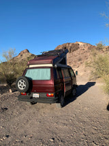  a red pop-top camper van