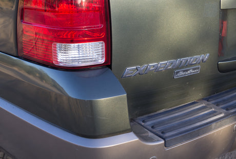 Rear right of a green Ford Expedition SUV with tail light and 'Eddie Bauer' badge. A large vehicle for your next rv rental adventure.