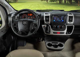 Inside an RV rental: a spacious driver's cockpit with steering wheel, digital dashboard, central screen, and cup holders.