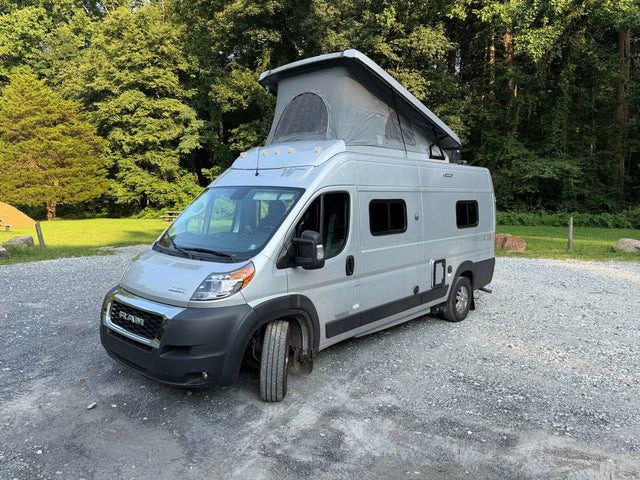 Silver campervan rv rental with an open pop-top roof