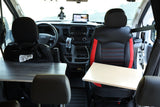 This RV rental interior features front seats, each with a small table, facing the organized dashboard, ideal for travel.
