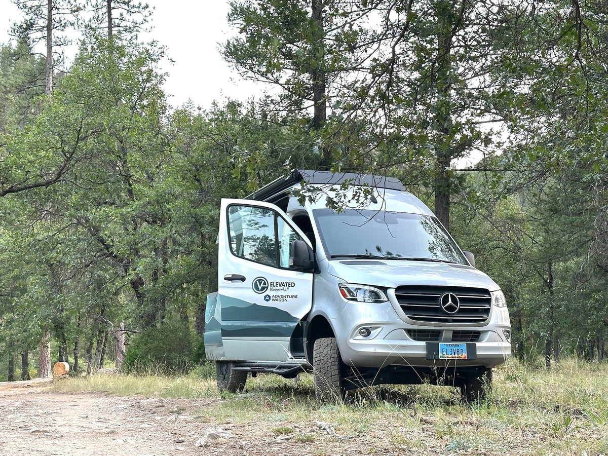  and organized overhead storage for adventures.|rv rental: well-appointed camper van interior with cozy bed — photo 8