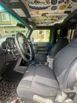 Inside a personalized blue Jeep, decked with adventure stickers on the roof. Perfect for an outdoor trip, like an rv rental journey.