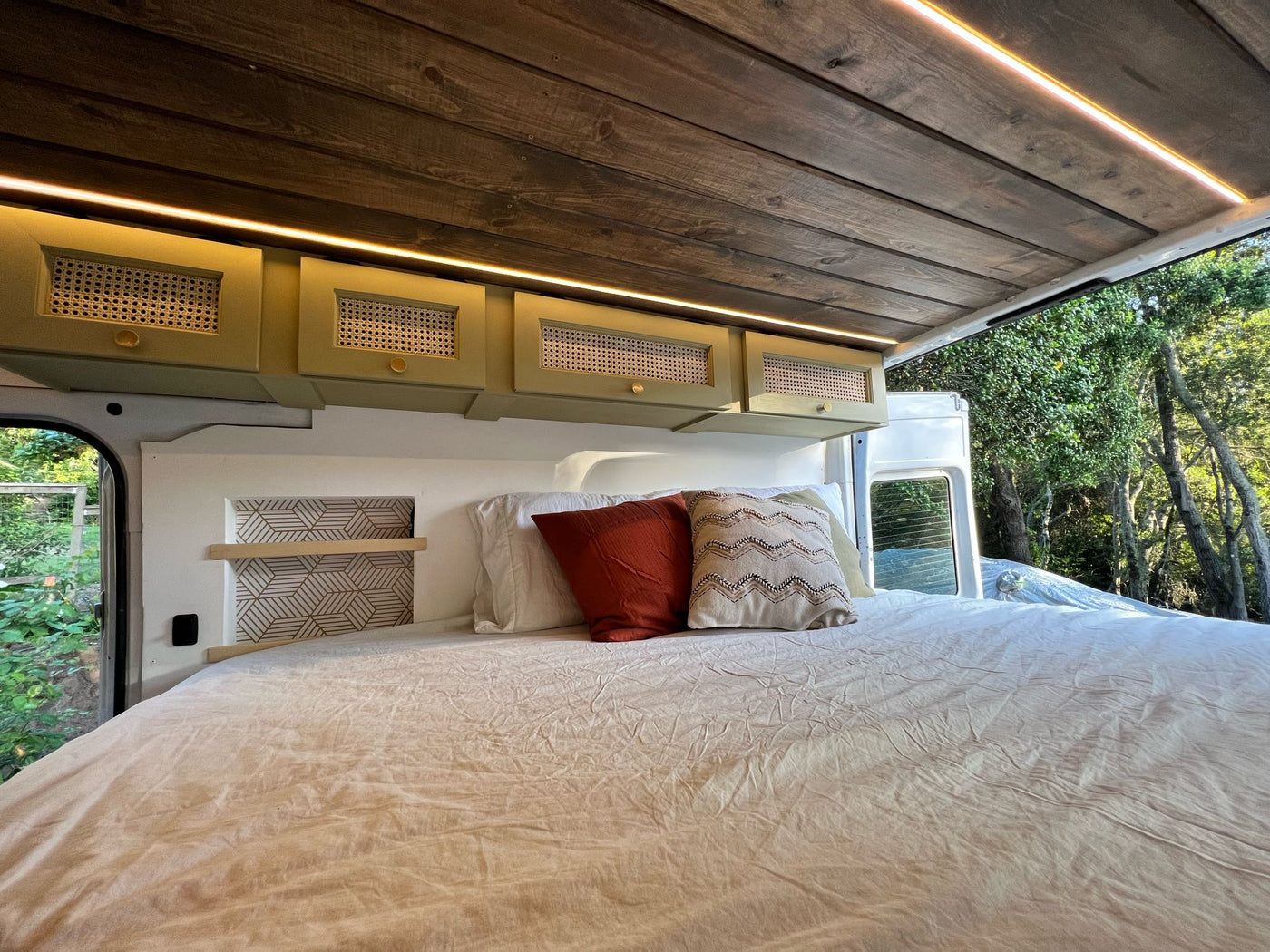  and kitchen area. Wooden ceiling adds warmth.|White Mercedes Sprinter camper van with custom interior & bed. Great for your next RV rental adventure!|Cozy RV rental interior with bed — photo 18