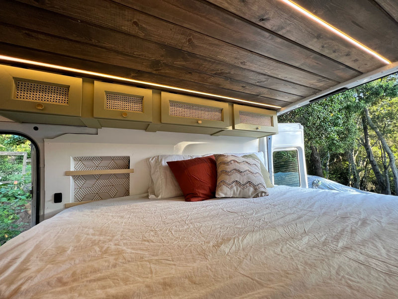  and kitchen area. Wooden ceiling adds warmth.|White Mercedes Sprinter camper van with custom interior & bed. Great for your next RV rental adventure!|Cozy RV rental interior with bed — photo 18