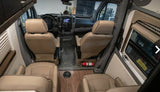 Spacious RV rental interior from back to front, featuring tan captain's chairs, a dashboard, and wood-look flooring.