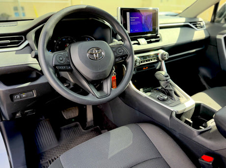 Modern car interior: steering wheel, dashboard, touchscreen display, and gear shift. Ready for your next rv rental road trip.