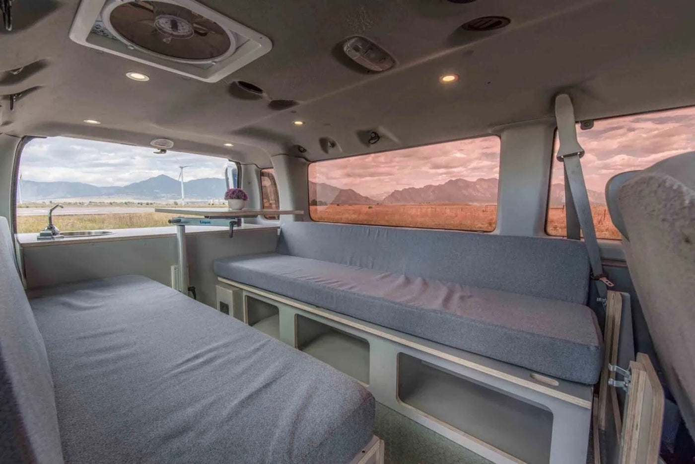  showcasing a comfortable gray bed and scenic outdoor views for mobile adventures.|Inside an RV rental: A comfortable — photo 14