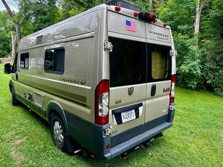  showing its side profile.|Olive green Winnebago Travato camper van