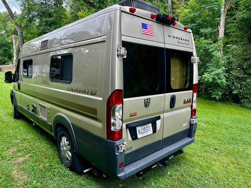  showing its side profile.|Olive green Winnebago Travato camper van — photo 4