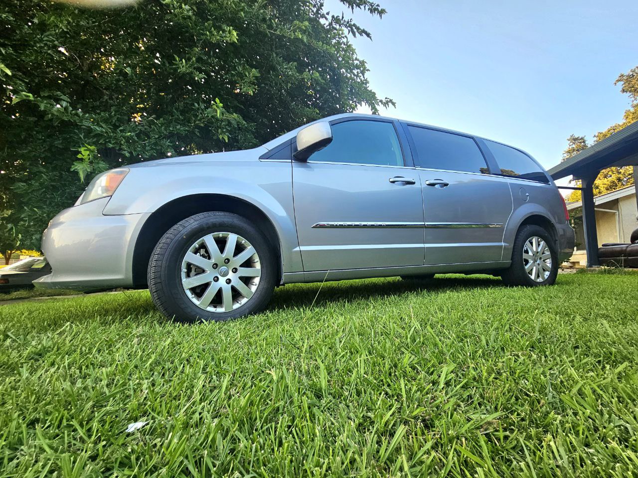 Silver minivan on grass. Spacious for road trips. See our vehicle options including RV rental. — photo 4