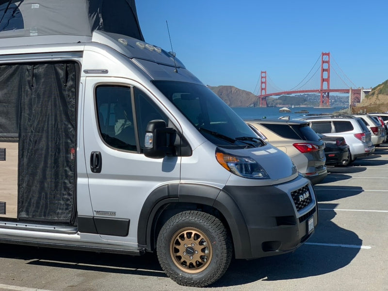 Silver pop-top RV rental van parked, with the iconic Golden Gate Bridge visible in the sunny background. — photo 2