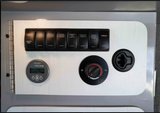 RV rental: Interior control panel for lights, water pump, fridge, Webasto heater, and Victron battery monitor.