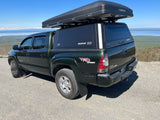 Toyota Tacoma with rooftop tent, a great RV rental alternative for exploring scenic mountain and lake views. Ideal for camping.