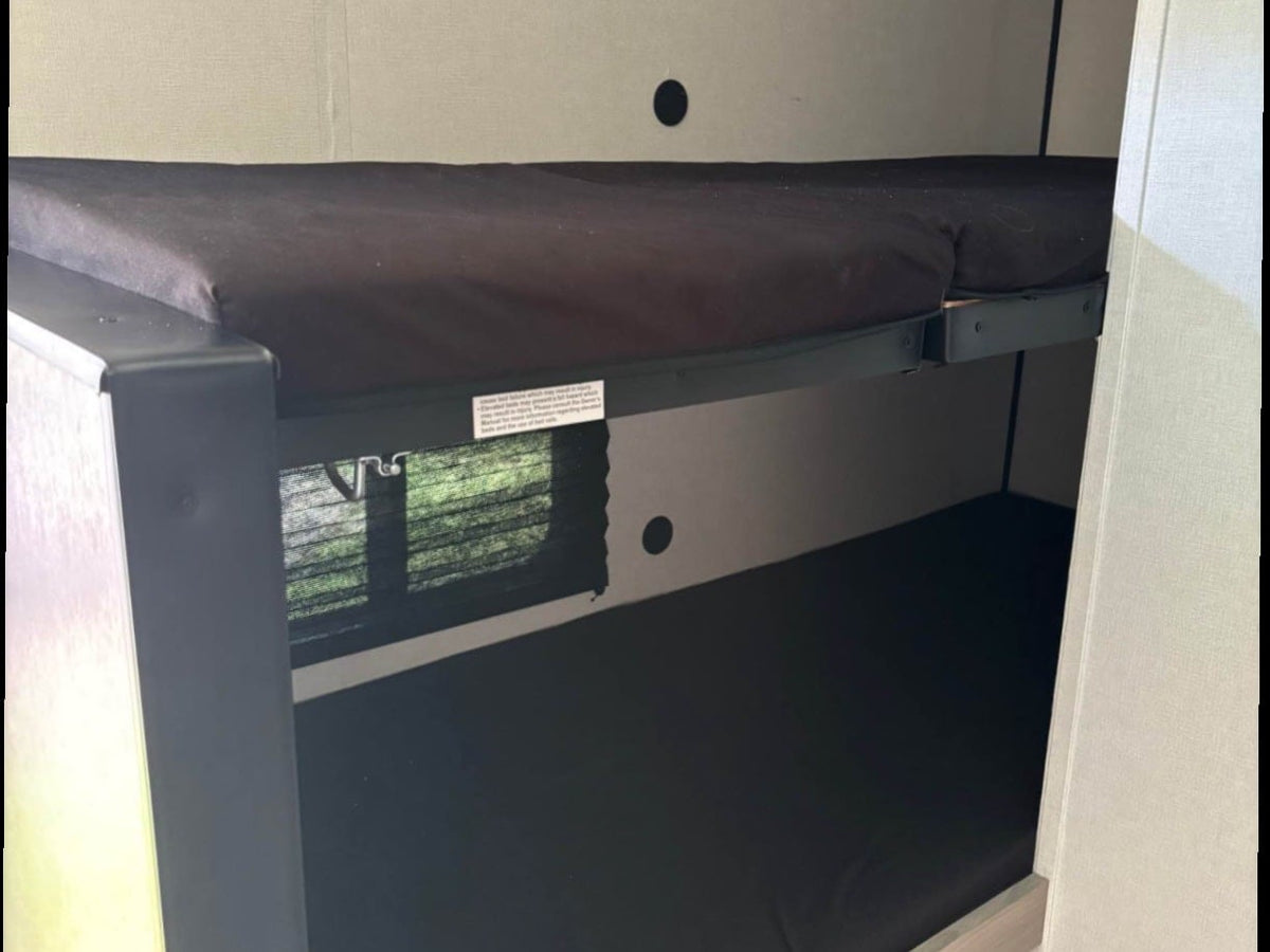  ready for your next outdoor adventure or camping trip.|Modern RV rental galley kitchen featuring a black microwave — photo 9