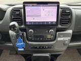 RV rental dashboard: Large infotainment screen, gear shifter with air freshener, USB ports, and HVAC controls for comfort.