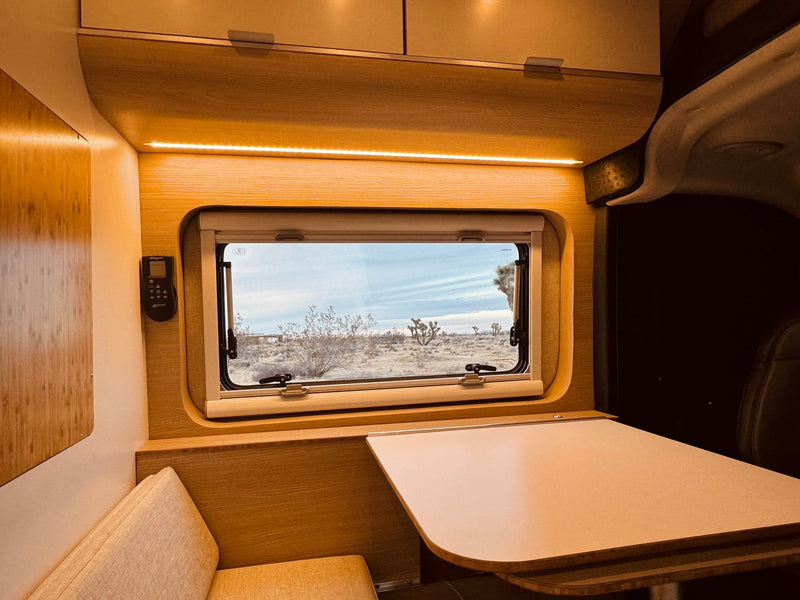  open refrigerator.|Cozy RV rental interior showcasing a patterned bed — photo 3
