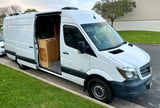 White Mercedes Sprinter camper van for rv rental, showing interior kitchen and roof solar panels.