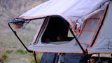An open roof-top tent set up for camping, offering a unique outdoor RV rental experience with scenic views.