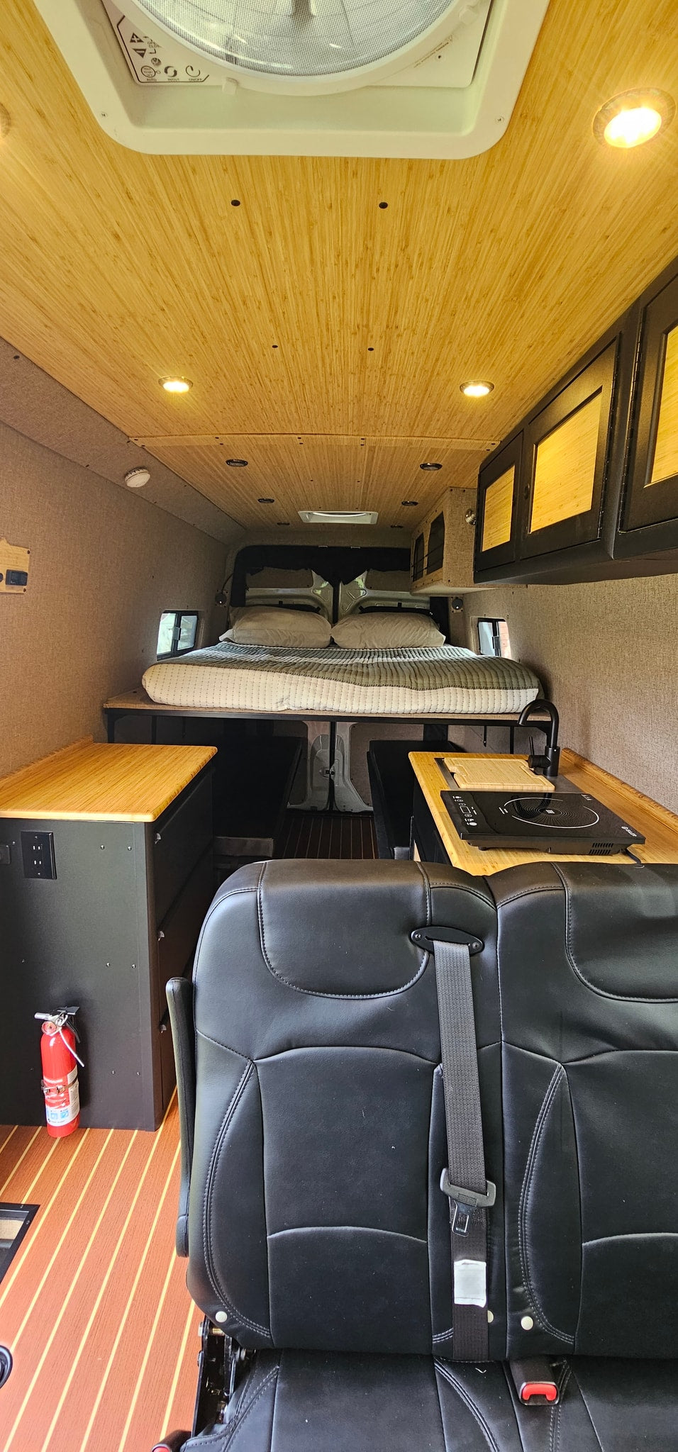  and grill on a muddy campsite amidst a spring forest.|Scenic RV rental: Camper van & gear in a mountain setting — photo 10