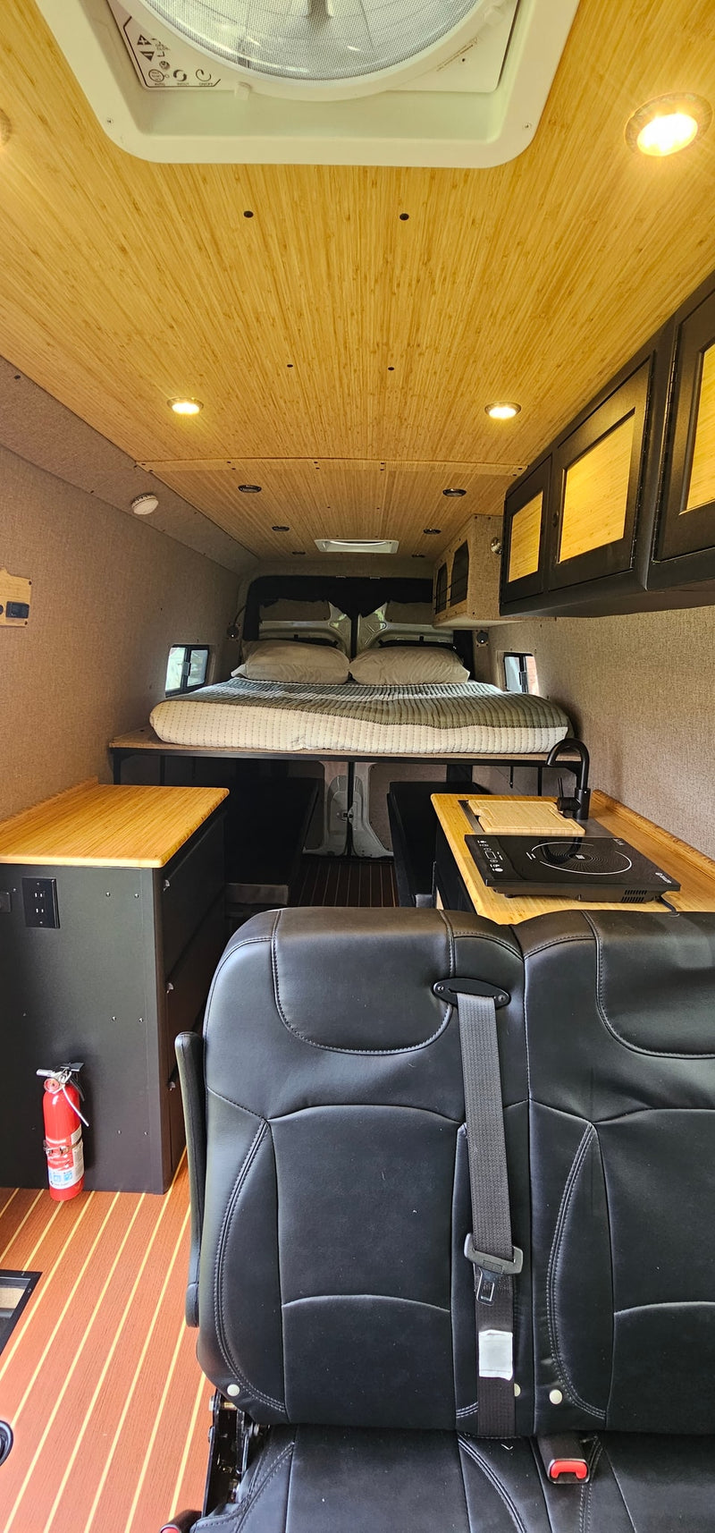 and grill on a muddy campsite amidst a spring forest.|Scenic RV rental: Camper van & gear in a mountain setting — photo 10