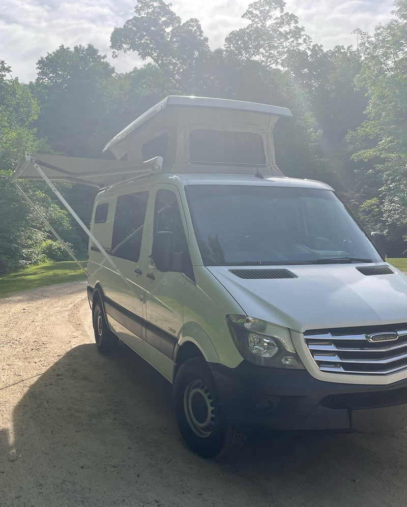  ideal for camping adventures.|This white Freightliner pop-top rv rental — photo 4
