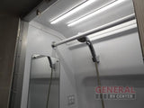 Bright RV rental shower stall with LED lights, a handheld showerhead, mirror, and grab bar.