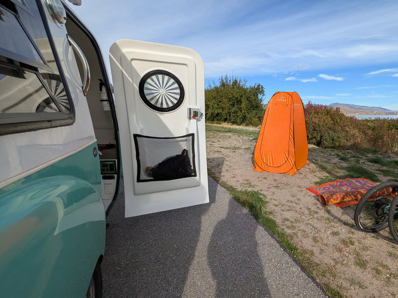  and small kitchen.|This rv rental's cozy campervan sleeping area features a Kelty sleeping bag on cushioned benches — photo 7